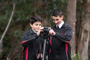 ERC-two-students-use-camera-together-outdoors